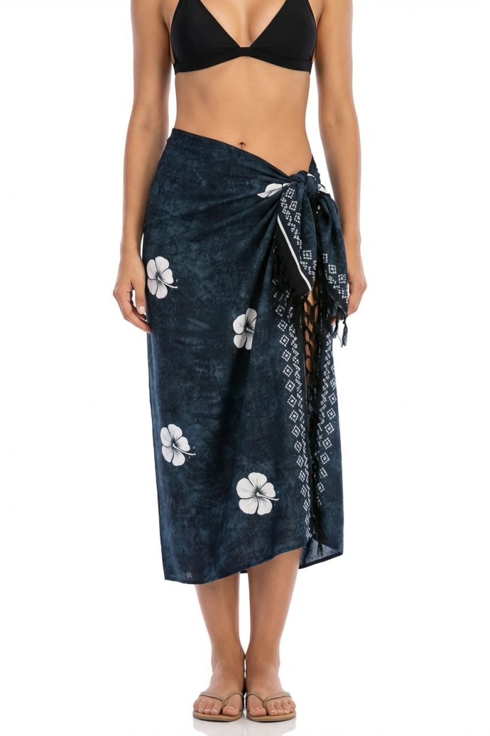 Woman wearing a black floral sarong on a white background