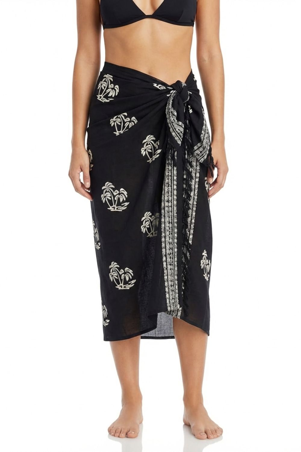 Black patterned sarong worn by a person on a white background