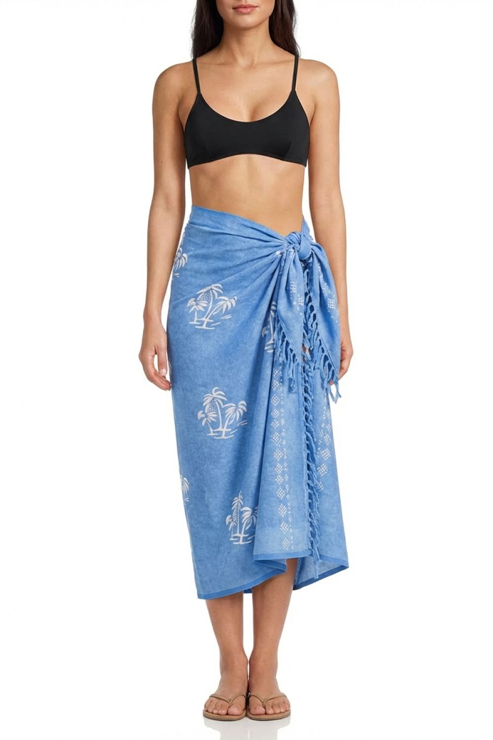 Woman wearing a blue sarong with white patterns on a white background