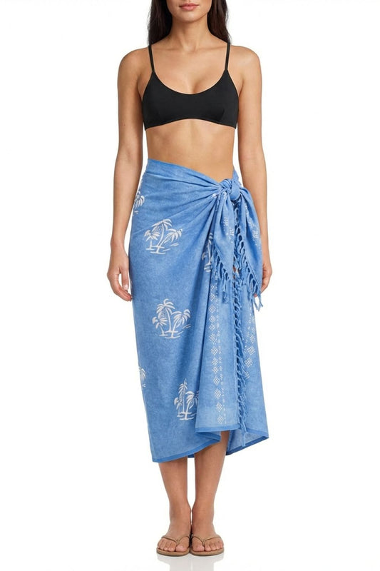 Woman wearing a blue sarong with white patterns on a white background