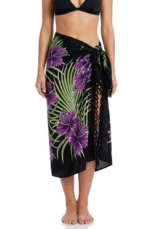 Black sarong with purple floral design worn by a person on a white background