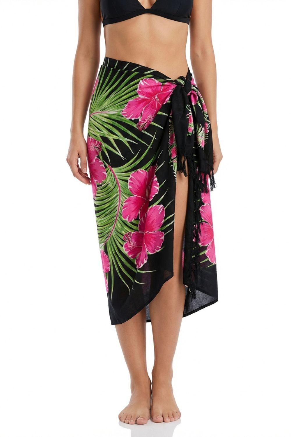 Tropical floral sarong with pink flowers and green leaves on a black background