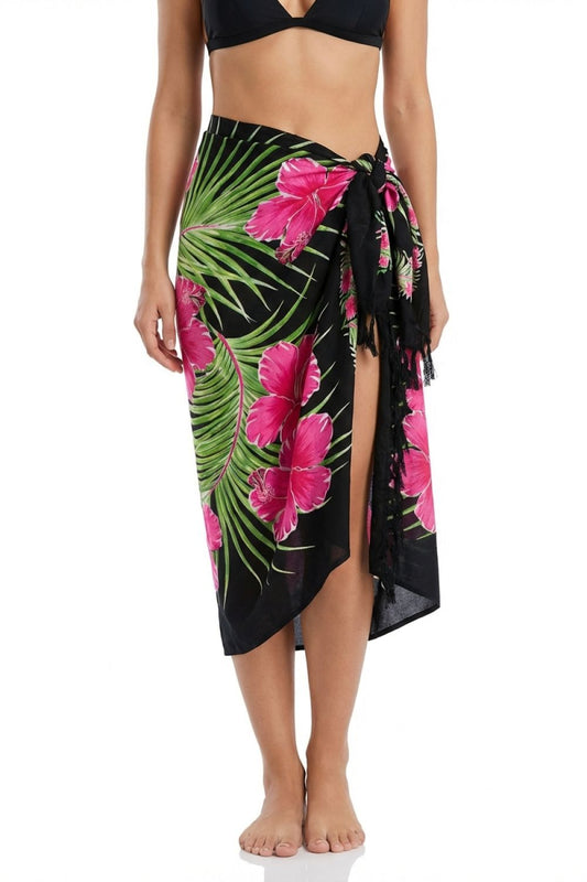 Tropical floral sarong with pink flowers and green leaves on a black background