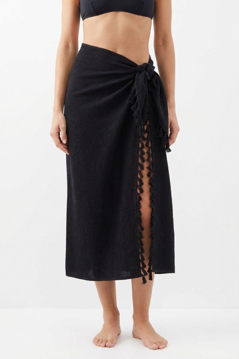 Solid black sarong worn by a woman in a white background