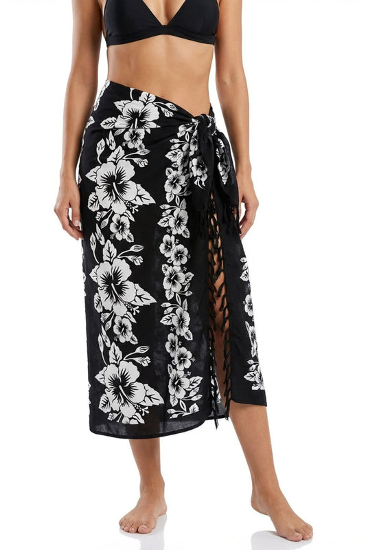 Woman wearing a black floral sarong on a white background
