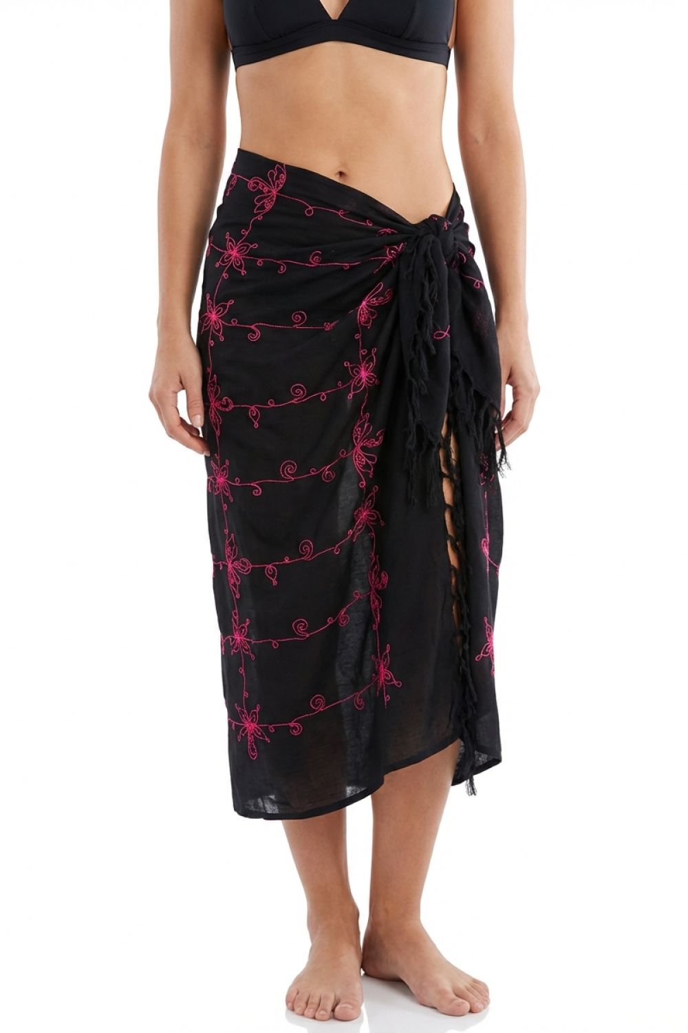 Black sarong with pink floral patterns worn by a person on a white background