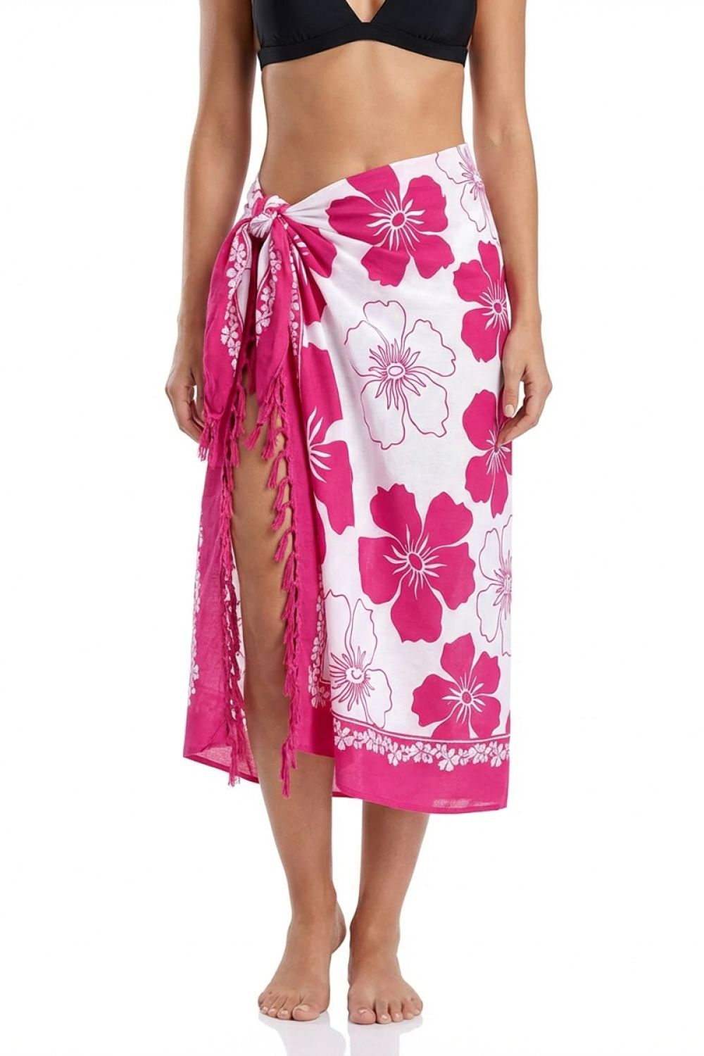 Woman wearing a pink floral sarong on a white background