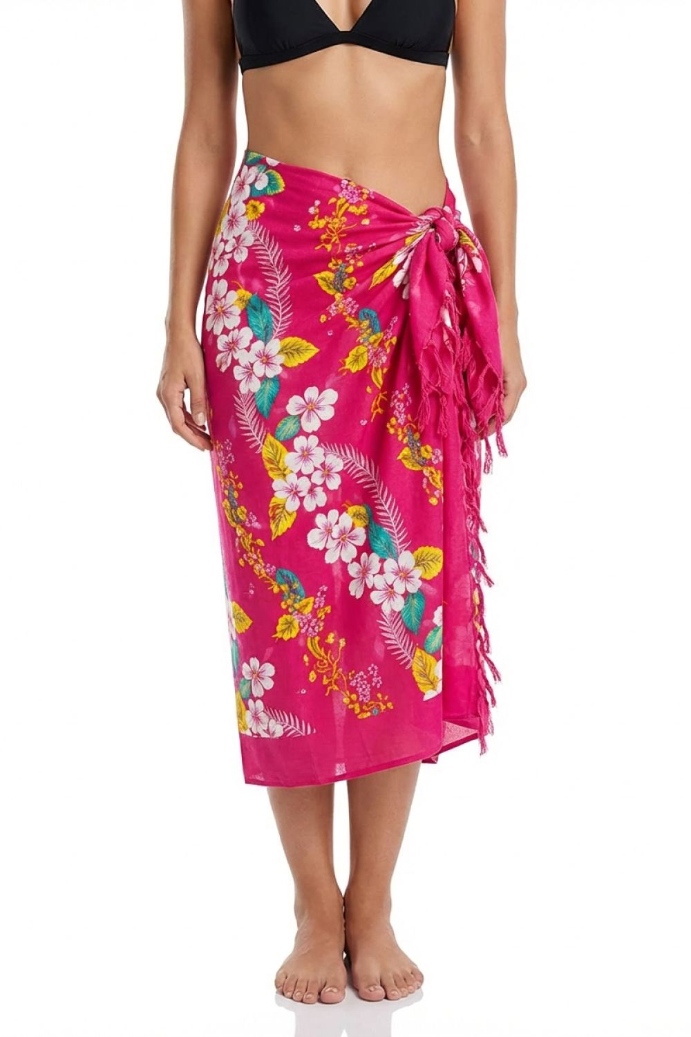 Woman wearing a bright pink floral sarong on a white background