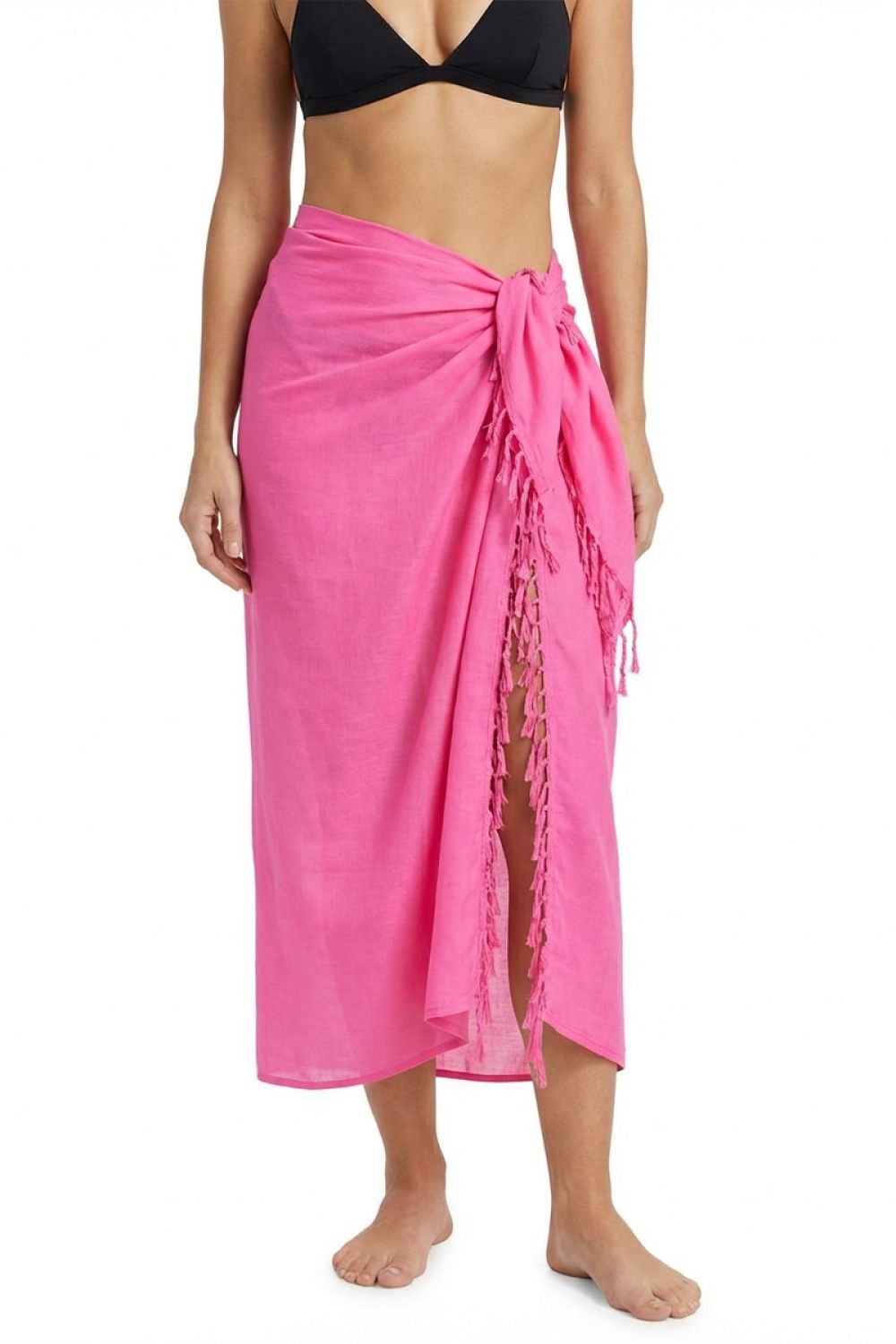 Person wearing a bright pink sarong over black bikini on a white background