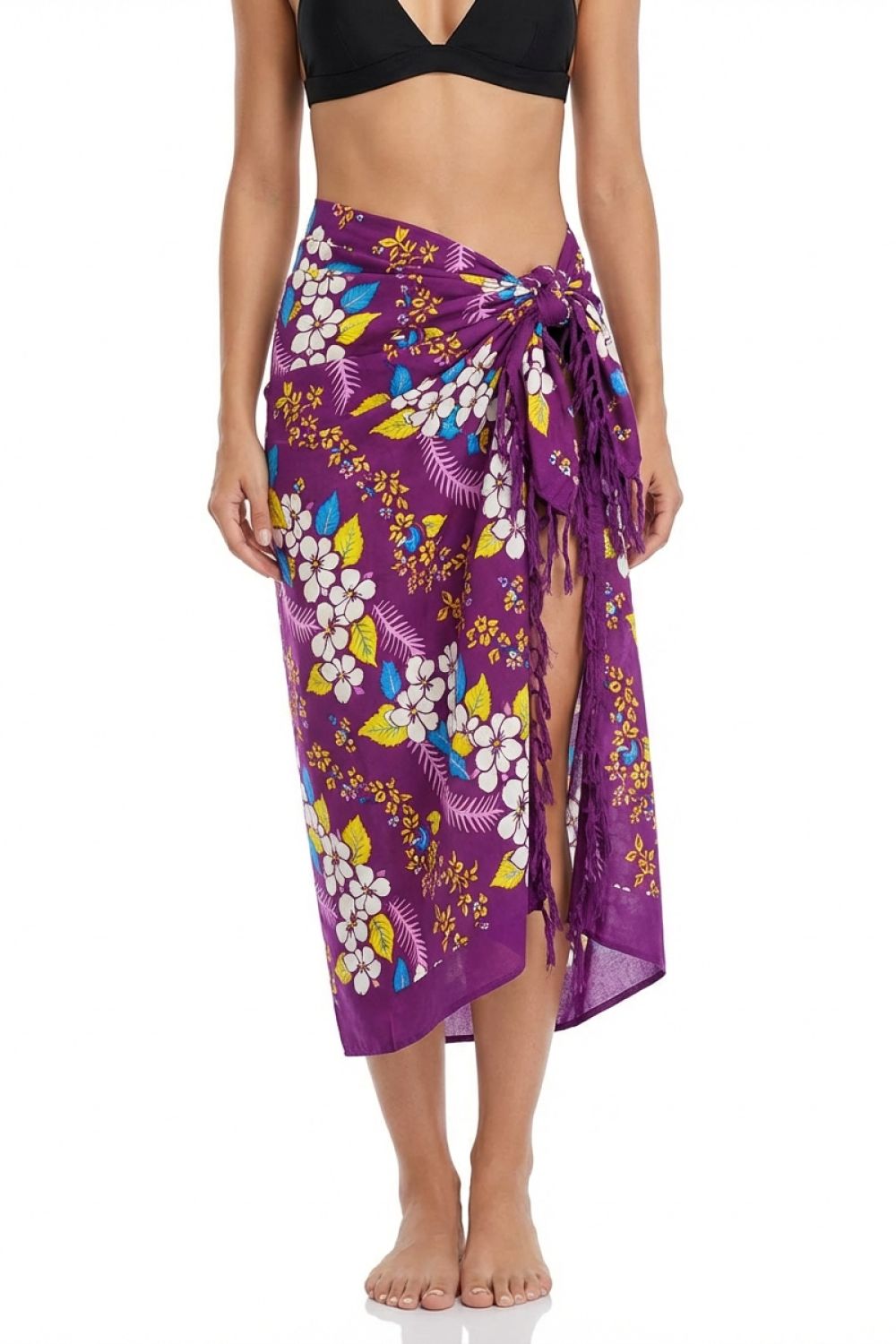 Woman wearing a purple floral sarong on a white background
