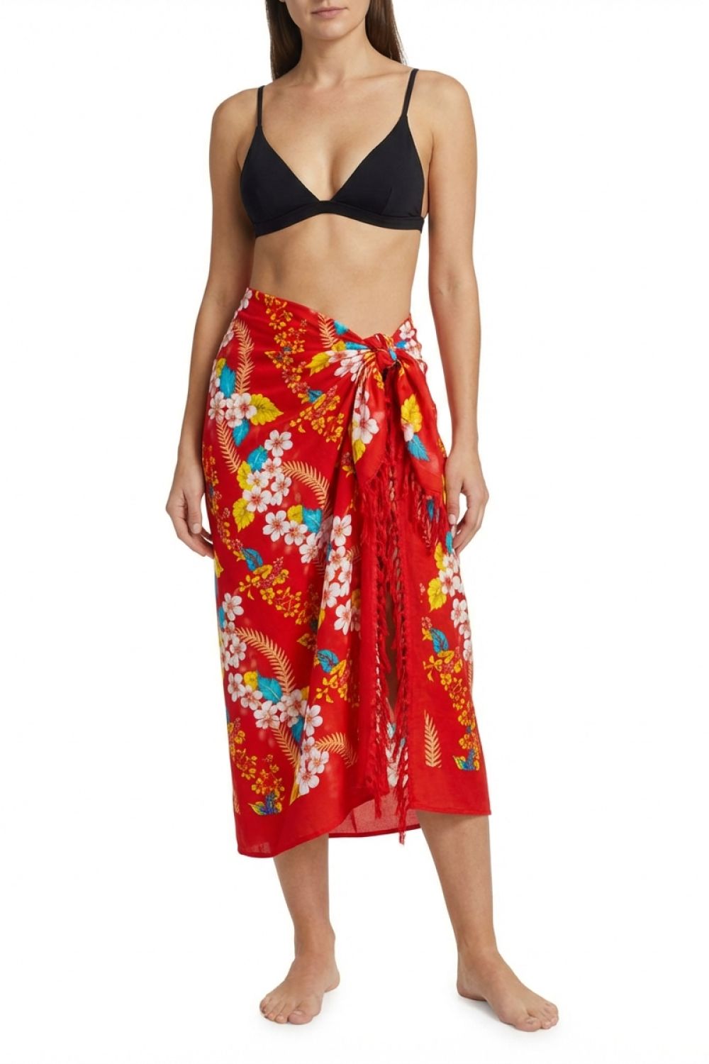 Woman wearing a black bikini top and red floral sarong on a white background