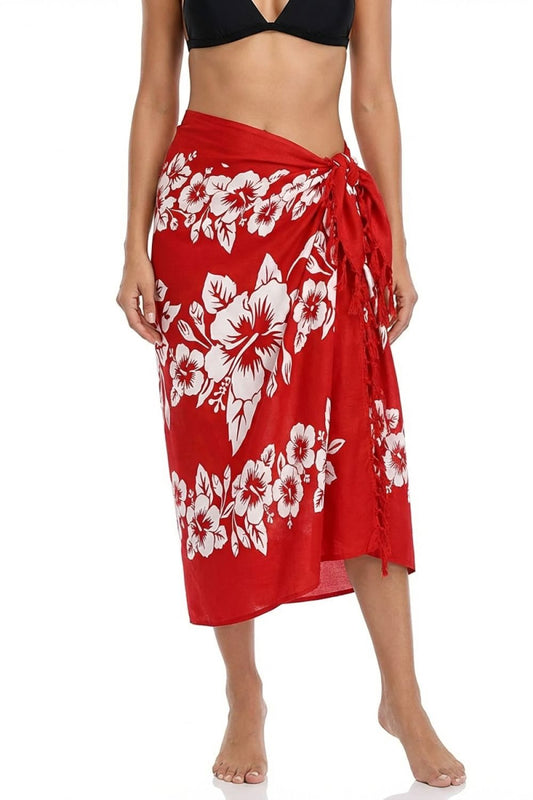 Red floral sarong worn by a person on a white background