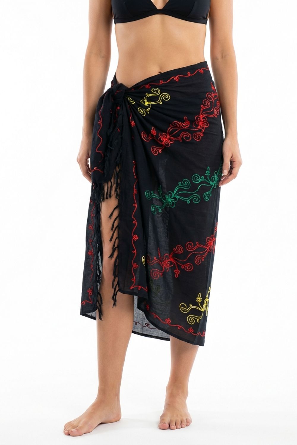 Black embroidered wrap skirt worn by a person on a white background