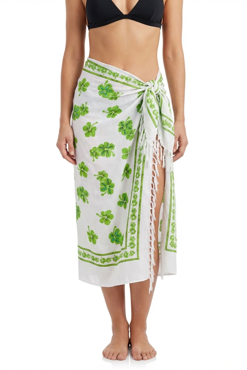 Woman wearing a white sarong with green floral patterns on a white background