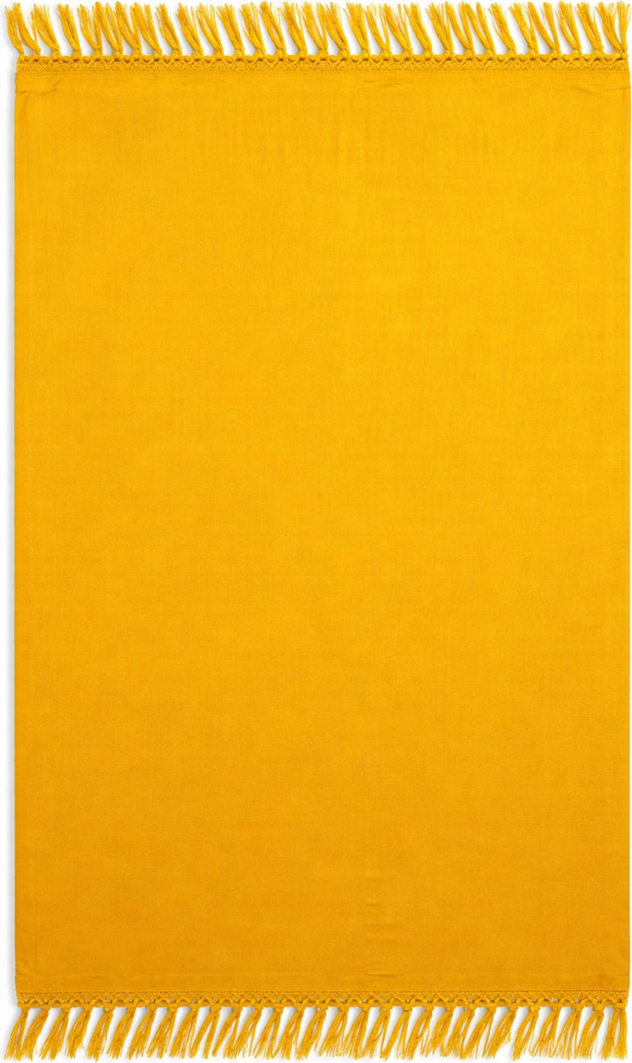 Yellow  sarong with fringe on a plain background