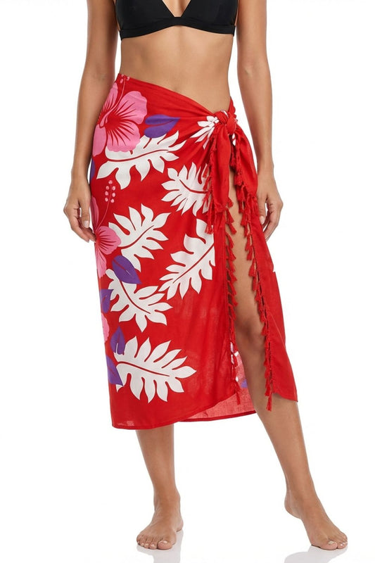 Red floral sarong worn by a person on a white background