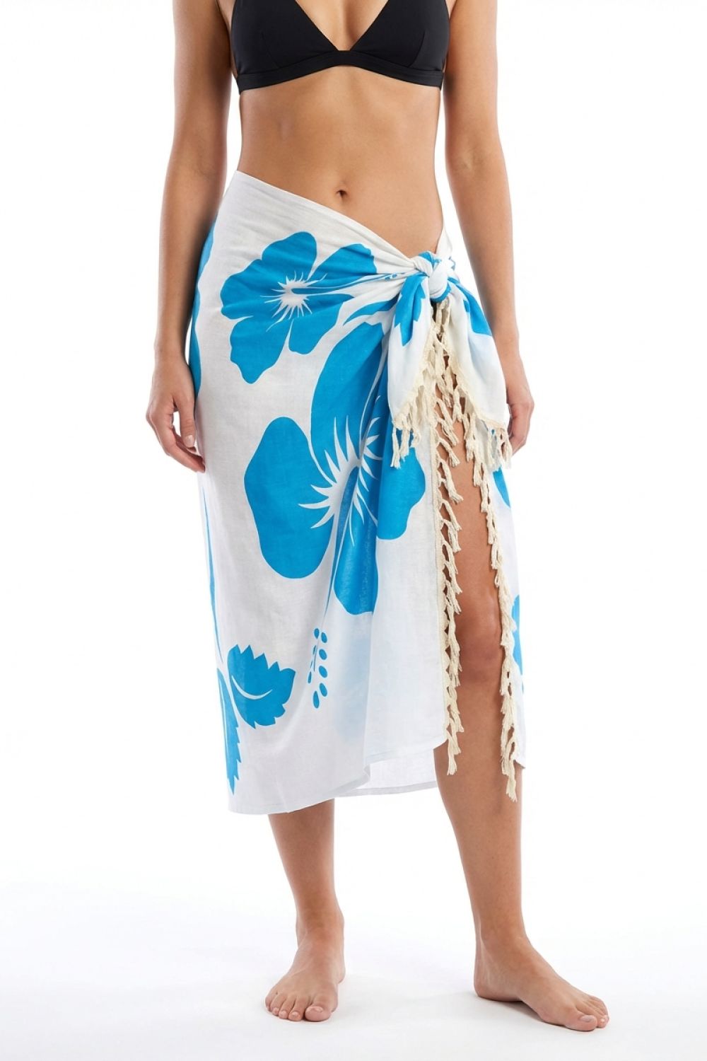 Person wearing a white sarong with blue floral patterns on a white background