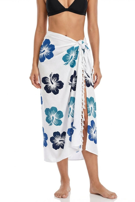Woman wearing a white sarong with blue floral patterns on a white background