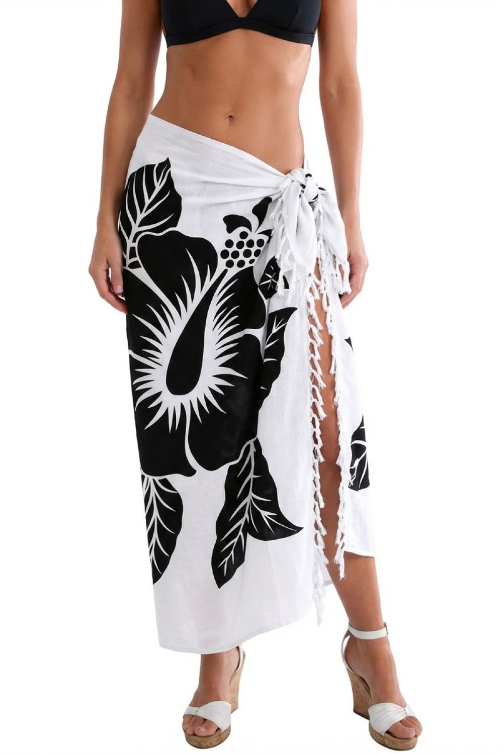 Woman wearing a white sarong with black floral patterns on a white background