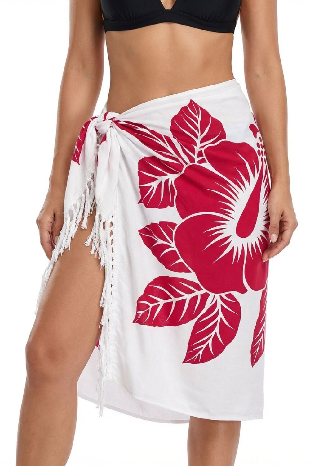 White sarong with pink floral patterns worn by a person on a white background