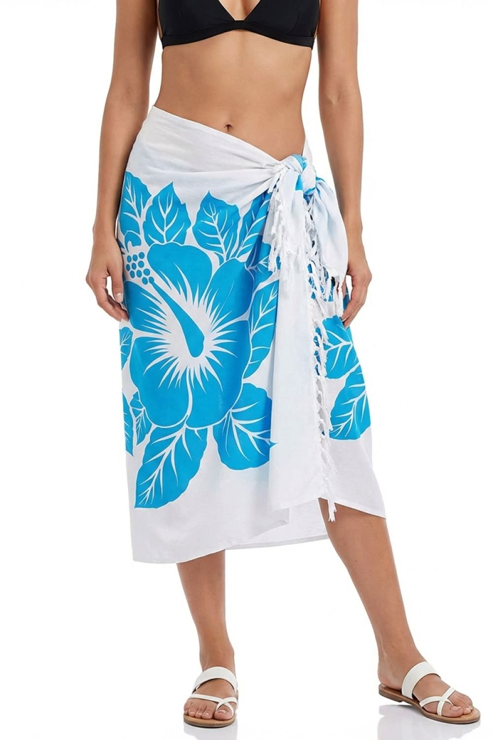 Woman wearing a white sarong with blue floral patterns on a white background