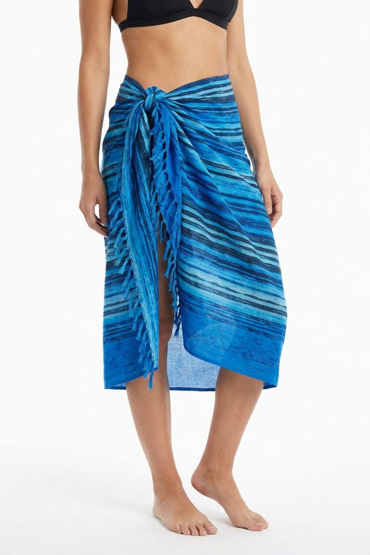 Woman wearing a blue striped sarong on a white background