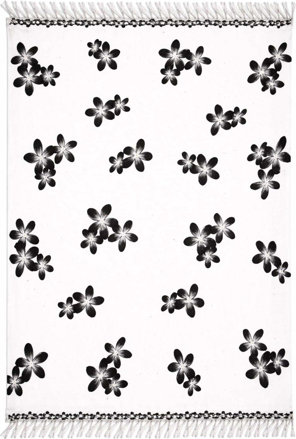 White sarong with black floral pattern and fringe on edges