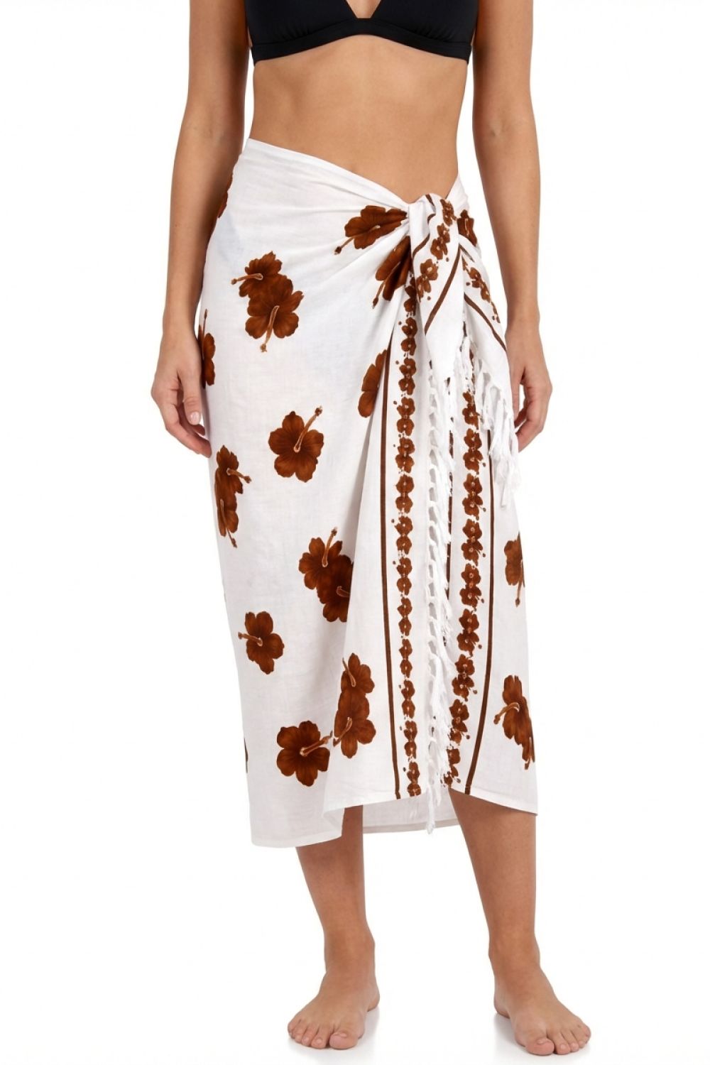 Woman wearing a white sarong with brown floral patterns on a white background
