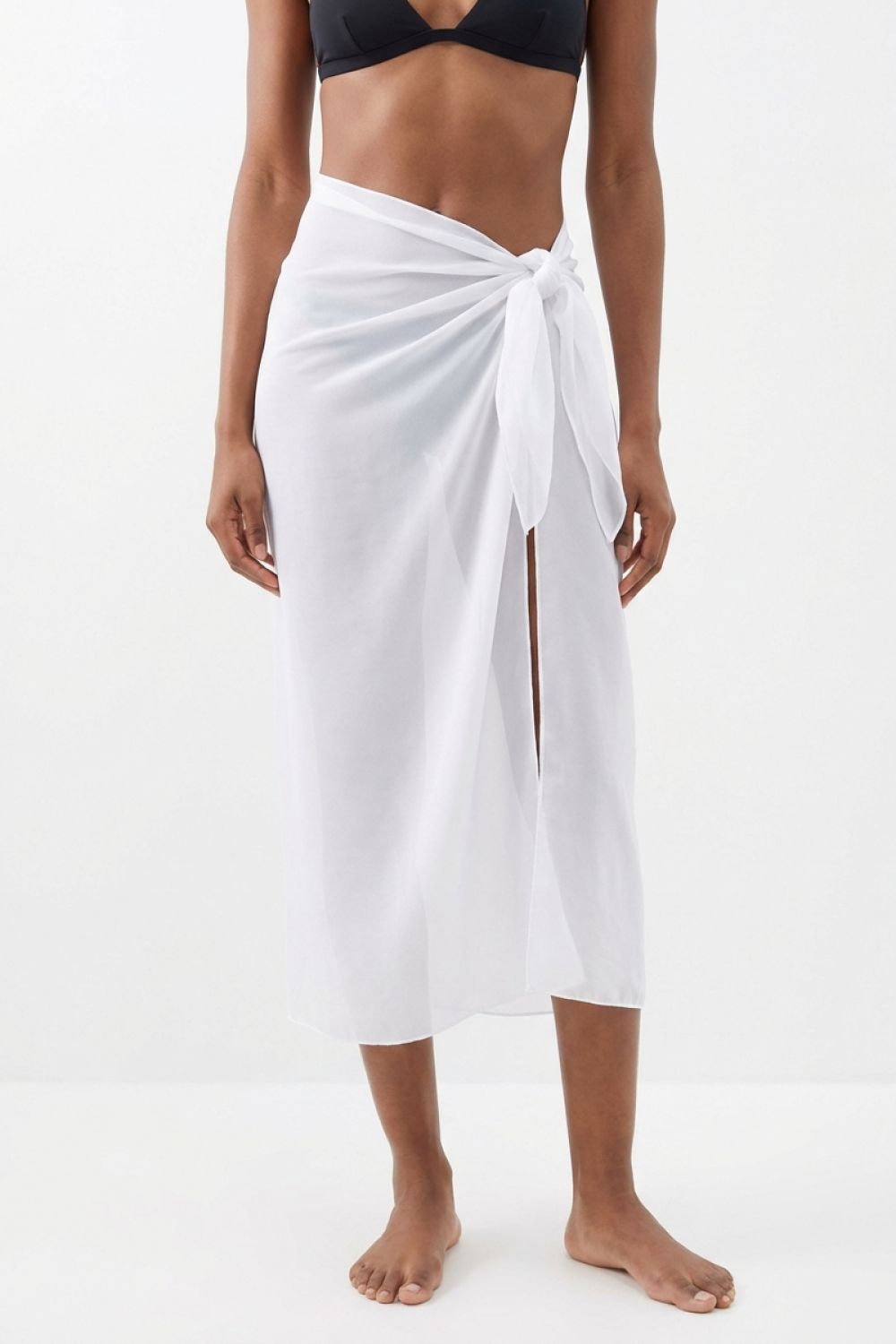 Sheer full length solid white sarong worn by a woman.